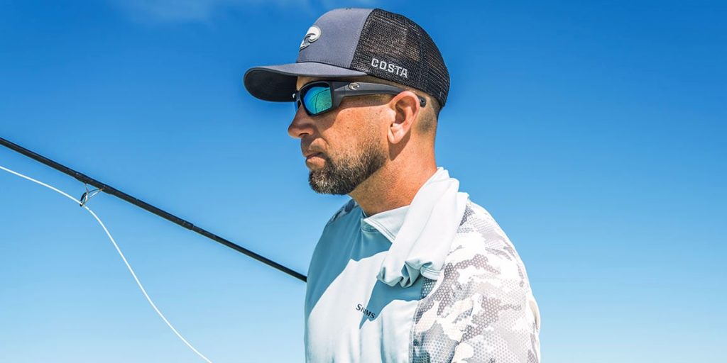 Man wearing a hat with Costa Fantail Pro sunglasses in Blue Mirror polarized lenses. | Best sunglasses for fly fishing | Jumping Rise