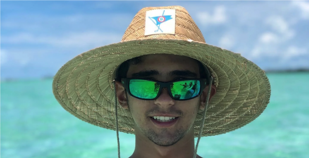 Man with a large straw hat wearing Maui Jim Local Kine sunglasses in MAUIGreen lenses | Best fly fishing sunglasses | Jumping Rise