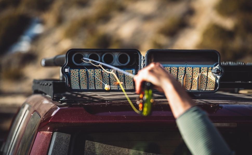 River Quiver Fly Rod Roof Rack -
The River Quiver has a side swing door that makes it easier to open and close while on top of your vehicle. River Quiver's door hinge design is clever, with an indent or gentle resistance mechanism that holds the door open in the wind and only requires a gentle push to close.
